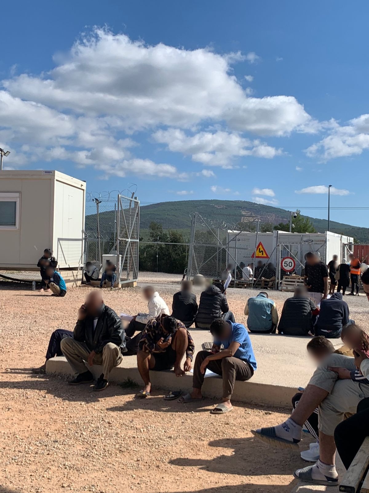 People waiting outdoors to attend doctors appointments in Malakasa RIC.