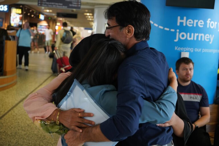 A family embracing as they are reunited.